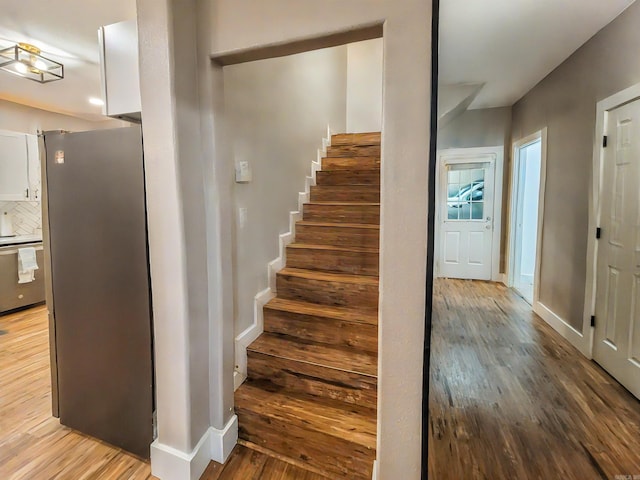 stairs featuring hardwood / wood-style flooring