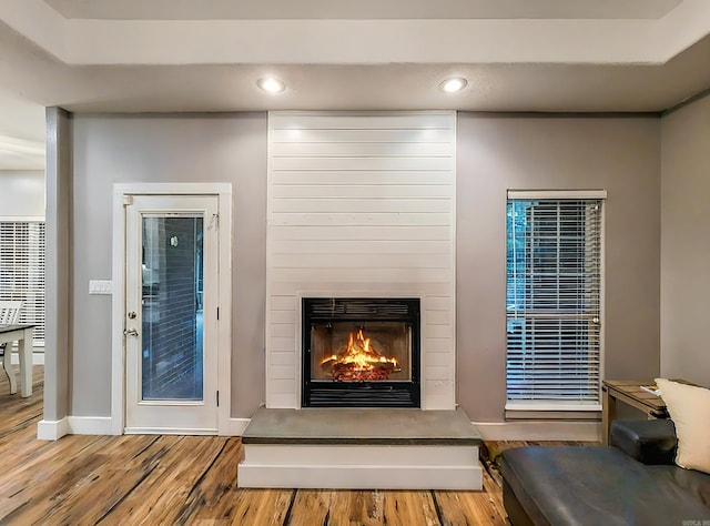 interior details featuring a large fireplace and hardwood / wood-style floors