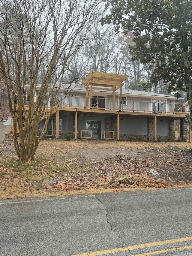 view of front facade with a pergola and a wooden deck