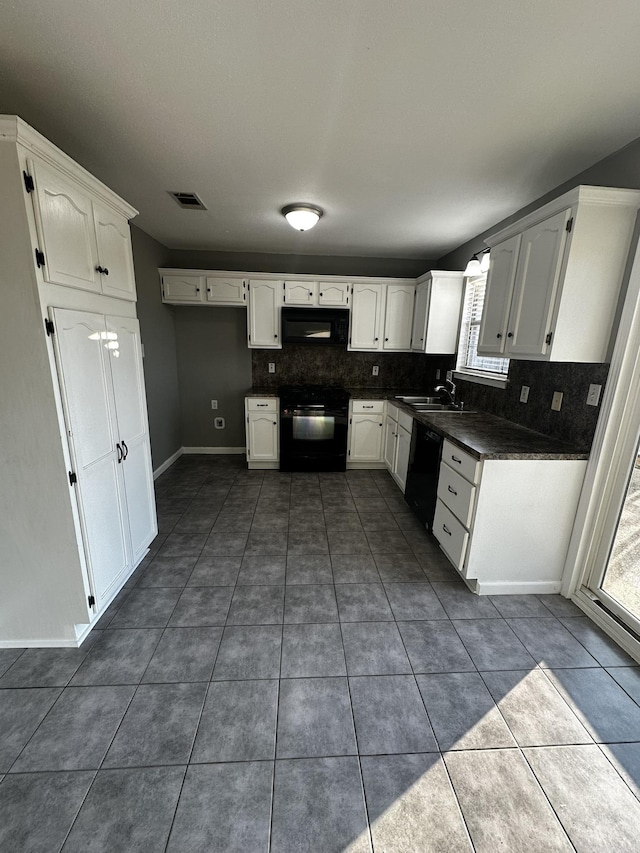 kitchen with black appliances, white cabinetry, sink, and a wealth of natural light