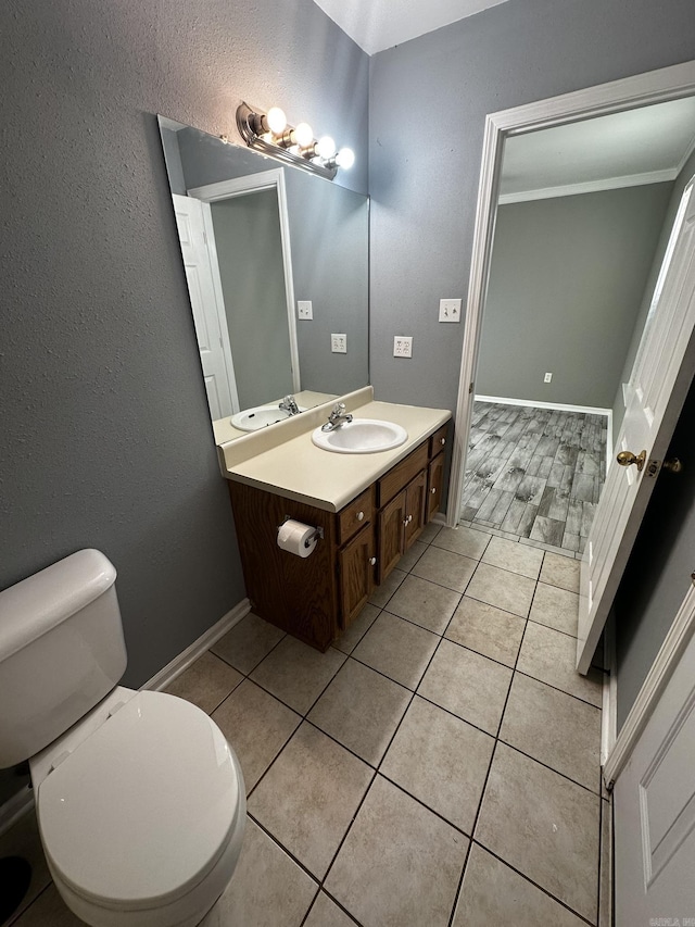 bathroom with tile patterned floors, vanity, and toilet