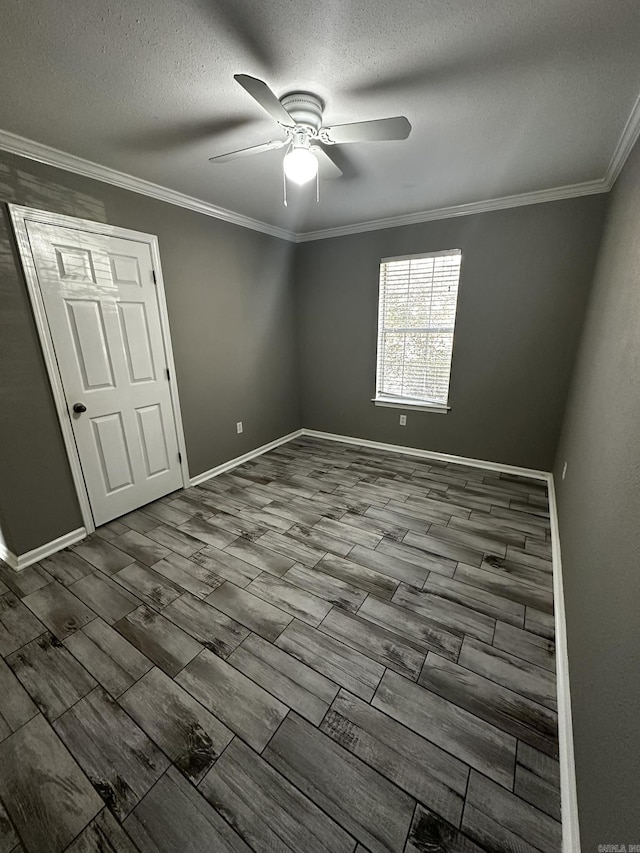 unfurnished bedroom with a textured ceiling, ceiling fan, and ornamental molding