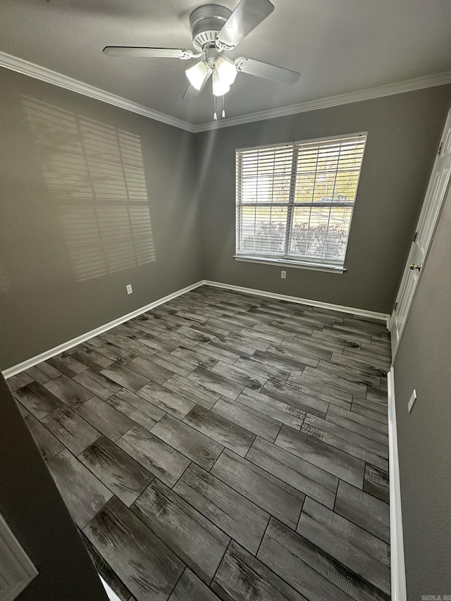 empty room with ceiling fan and crown molding