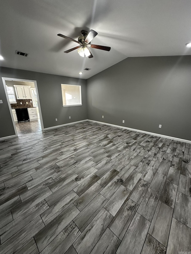 unfurnished room with ceiling fan and lofted ceiling