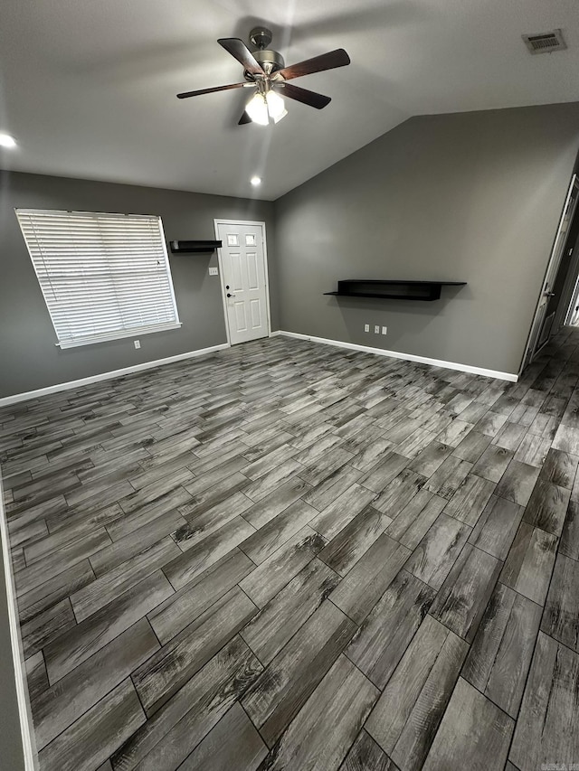 unfurnished living room featuring ceiling fan and lofted ceiling