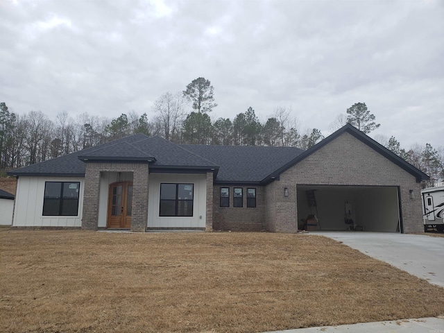 view of front of home with a front yard and a garage