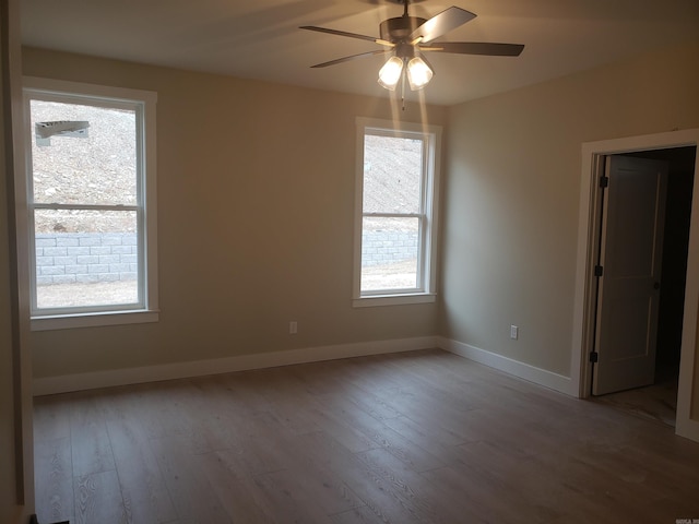 spare room with ceiling fan and light wood-type flooring