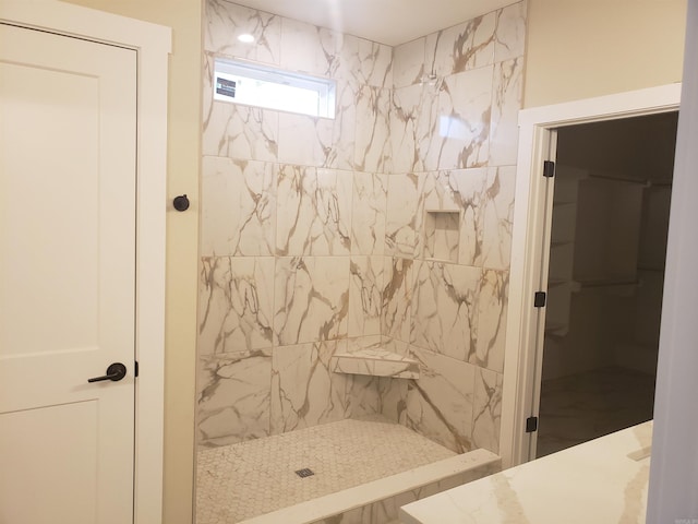 bathroom with a tile shower