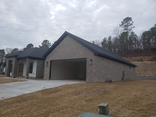 view of front of house with a garage and a front lawn