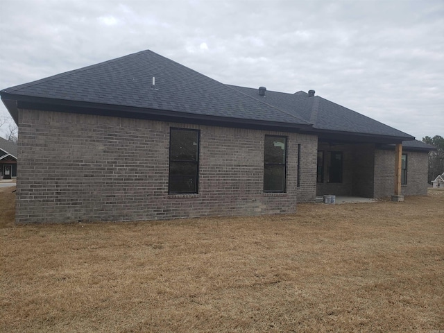 rear view of house with a yard