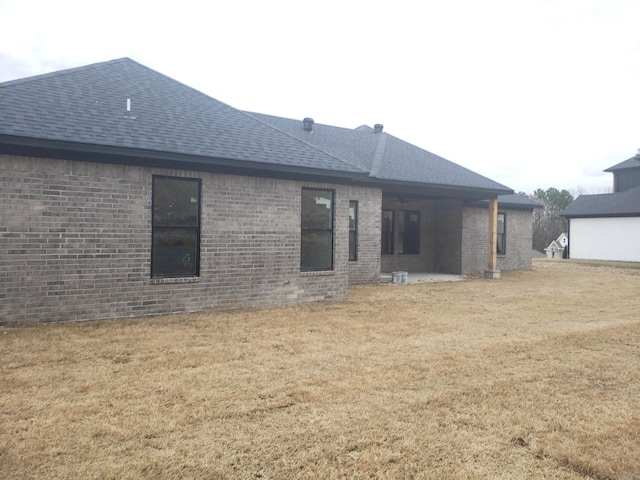 rear view of house with a lawn