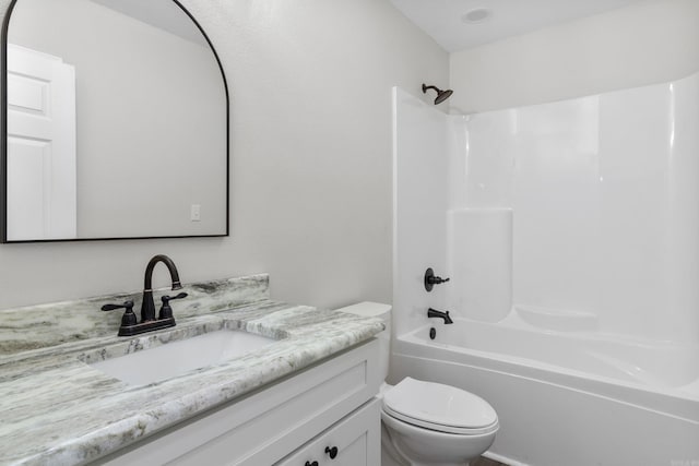 full bathroom featuring bathtub / shower combination, vanity, and toilet