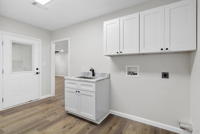 laundry area with cabinets, sink, hookup for a washing machine, hardwood / wood-style flooring, and hookup for an electric dryer