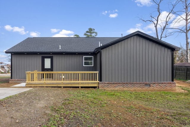 exterior space featuring a deck and a front lawn