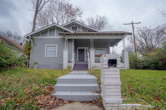 bungalow-style home with a front yard