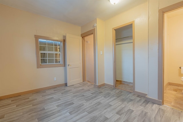 unfurnished bedroom featuring light hardwood / wood-style floors and a closet