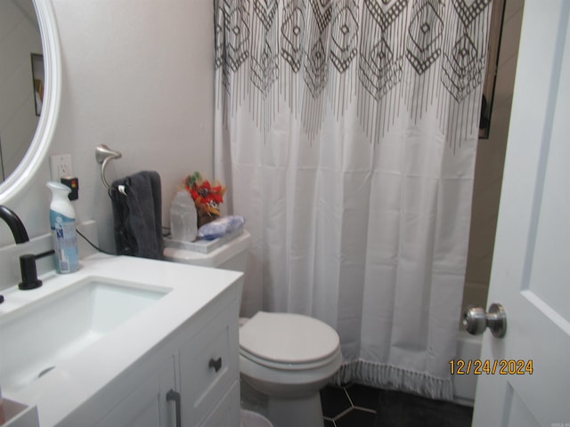 bathroom featuring toilet, a shower with curtain, vanity, and tile patterned floors