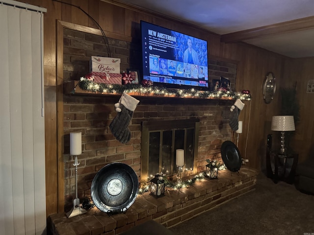 bar with carpet, wood walls, beam ceiling, and a brick fireplace