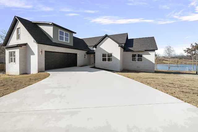 view of front of home with a water view and a garage