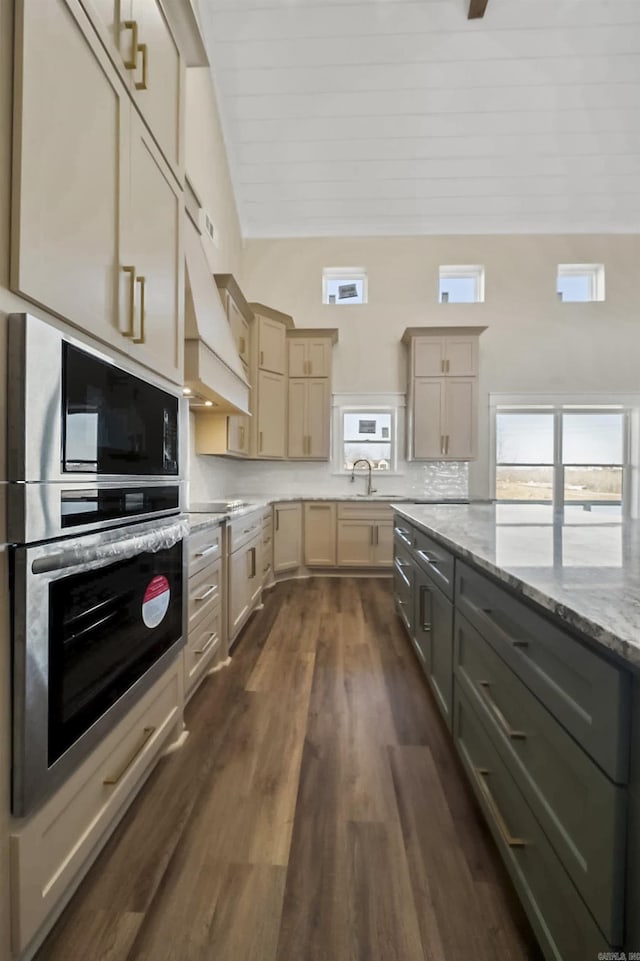 kitchen with wooden ceiling, backsplash, dark wood-type flooring, light stone counters, and extractor fan