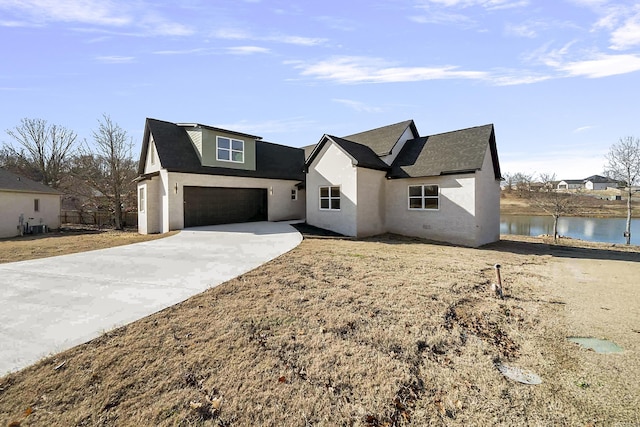 view of front of property with central AC unit, a garage, and a water view