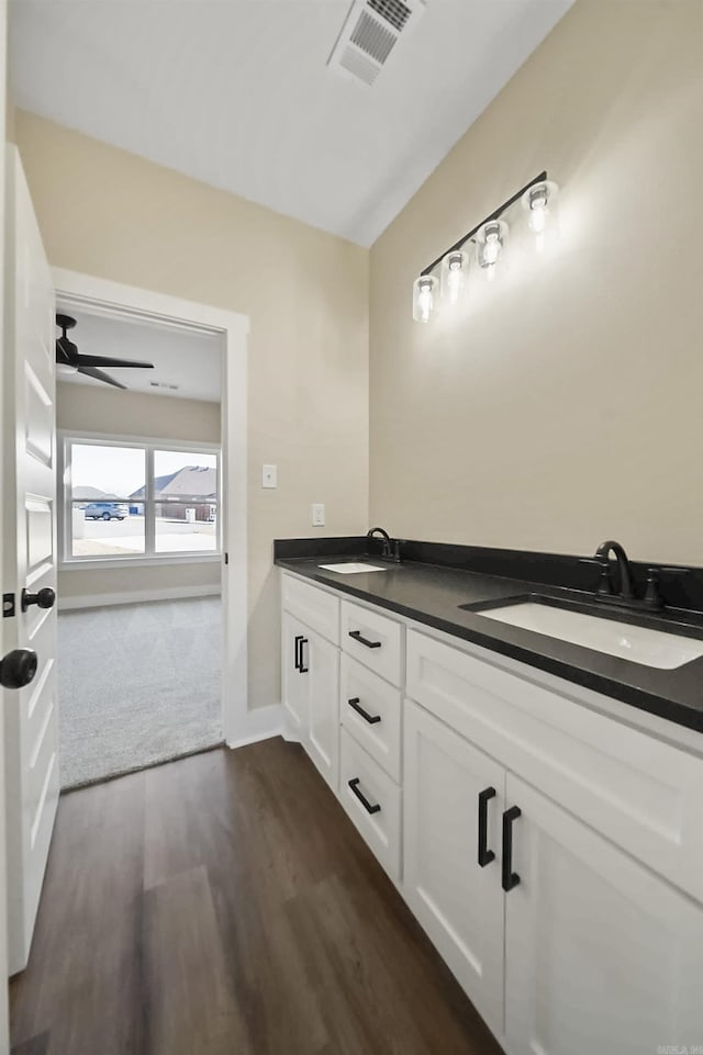 bathroom with hardwood / wood-style floors, vanity, and ceiling fan