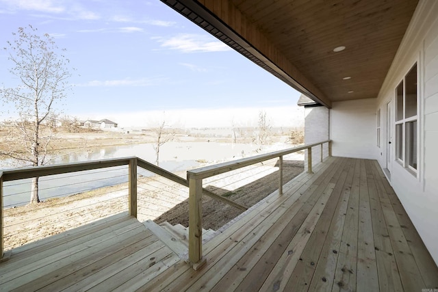 snow covered deck with a water view