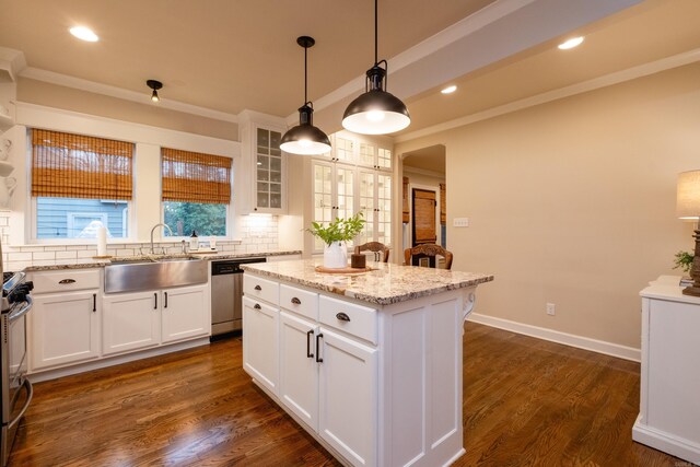 kitchen featuring a center island, white cabinets, and sink