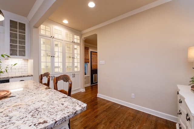 dining area with dark hardwood / wood-style floors and ornamental molding