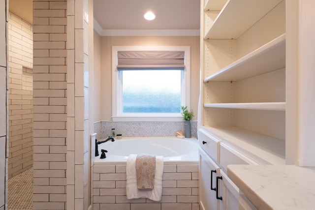 bathroom with vanity and tiled bath