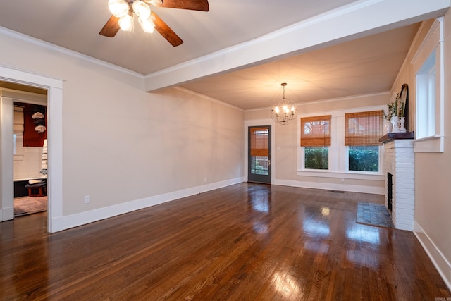 unfurnished living room featuring a fireplace, dark hardwood / wood-style floors, ceiling fan with notable chandelier, and ornamental molding