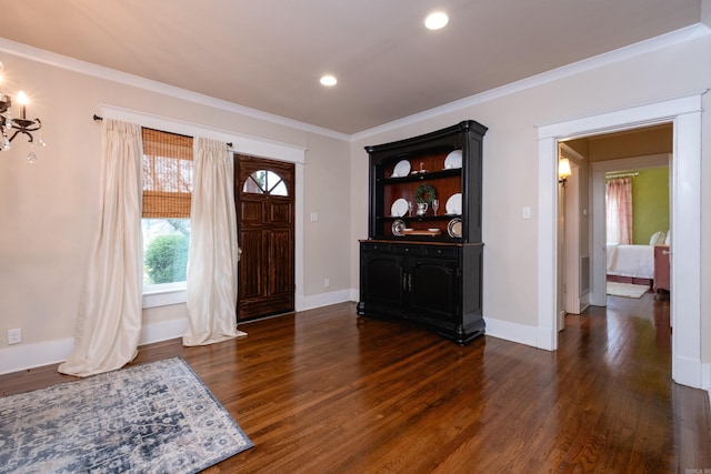 entrance foyer with dark hardwood / wood-style floors and ornamental molding