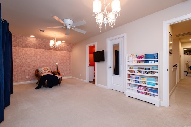 rec room with carpet and ceiling fan with notable chandelier