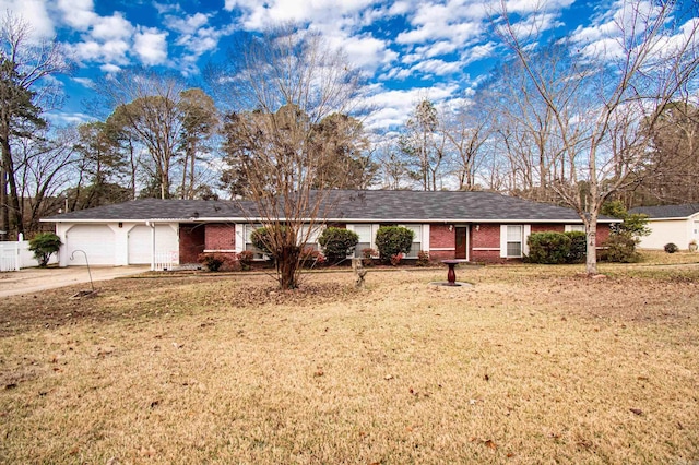 ranch-style home featuring a garage and a front lawn