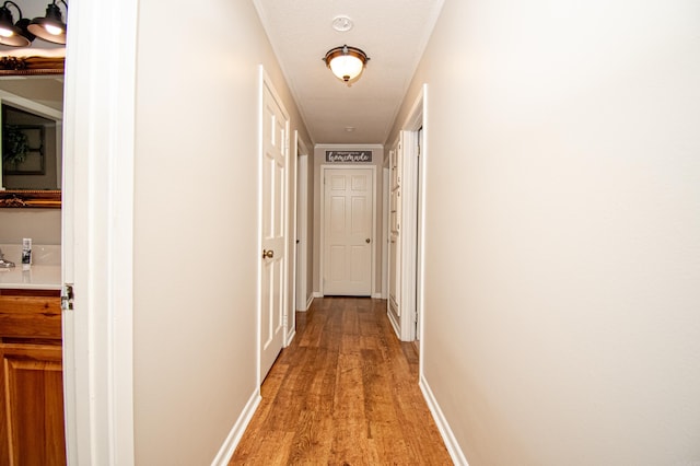 corridor featuring a textured ceiling and light hardwood / wood-style flooring