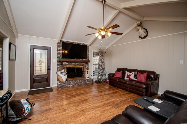 living room with hardwood / wood-style flooring, lofted ceiling with beams, ceiling fan, and a fireplace