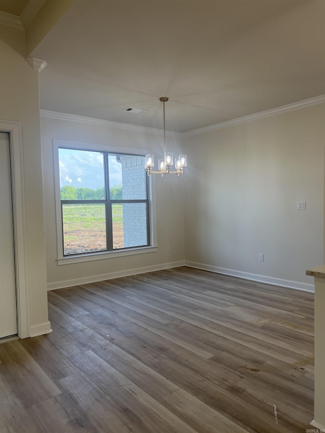 unfurnished dining area featuring a chandelier, baseboards, dark wood-style flooring, and crown molding