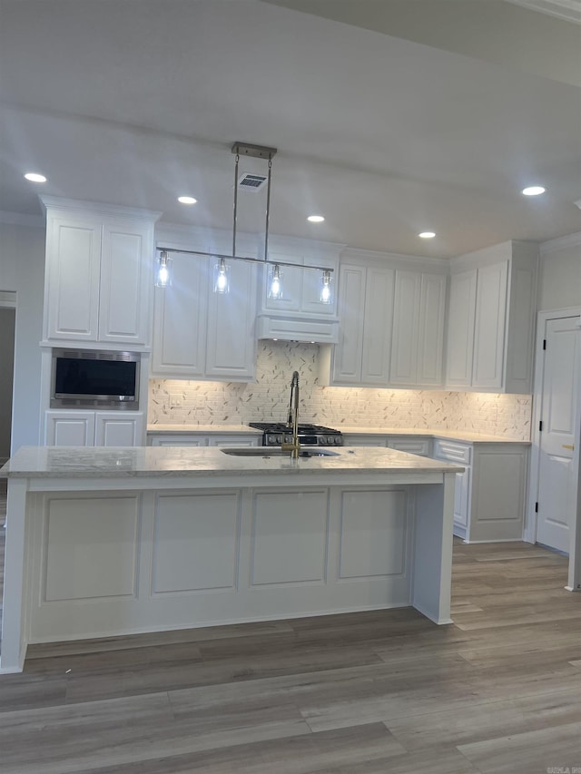 kitchen with ornamental molding, white cabinets, and backsplash