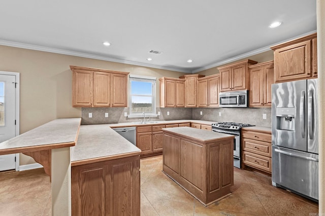 kitchen featuring stainless steel appliances, kitchen peninsula, decorative backsplash, a kitchen island, and ornamental molding