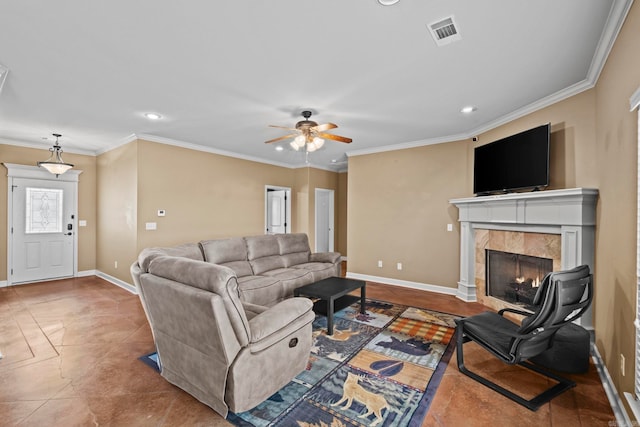 tiled living room featuring a tile fireplace, ceiling fan, and ornamental molding