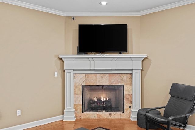 living area with crown molding, a fireplace, and hardwood / wood-style flooring