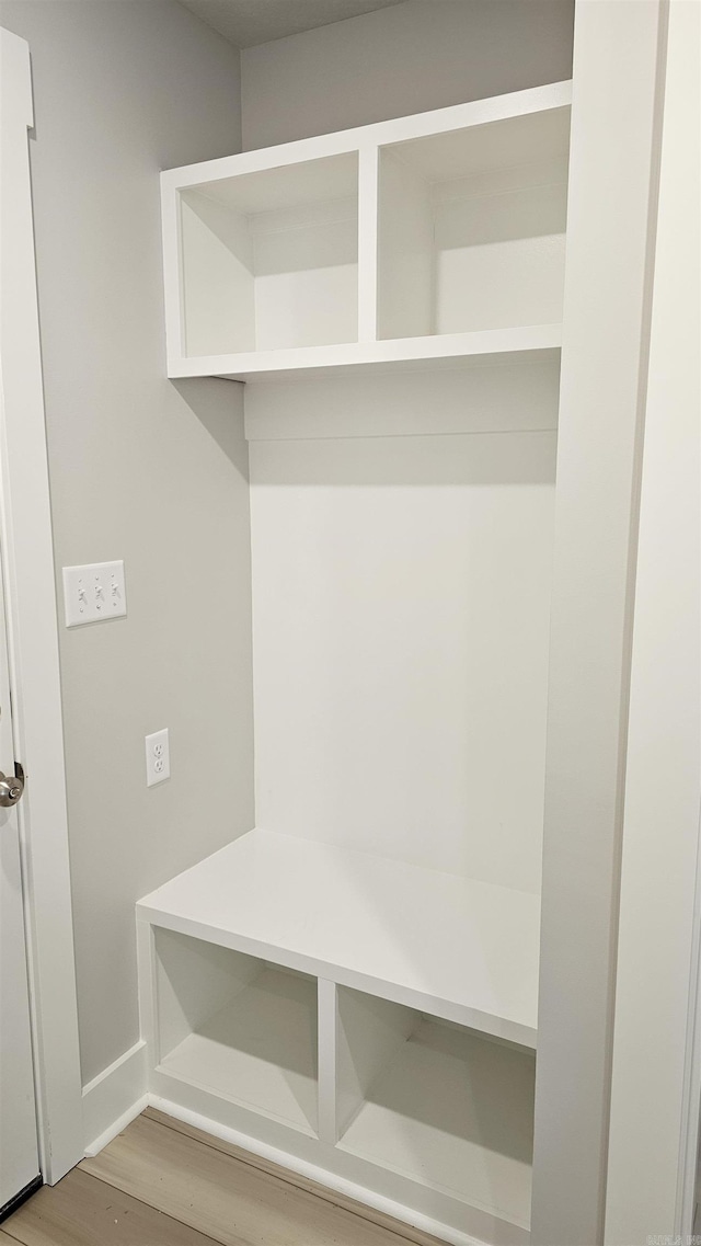 mudroom featuring light wood-style floors and baseboards