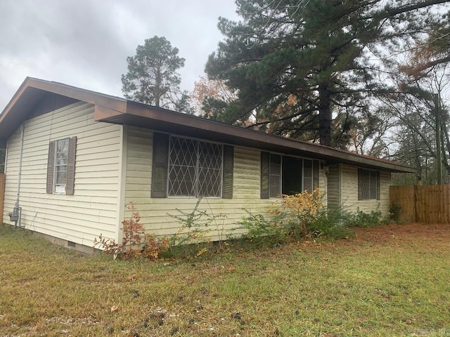 view of side of home with a lawn