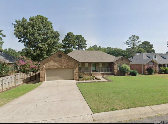 ranch-style house featuring a porch, a garage, and a front lawn