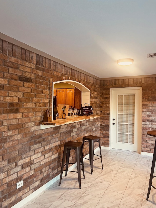 bar featuring brick wall