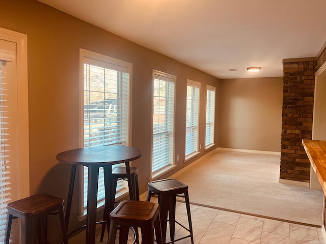 dining area featuring light colored carpet