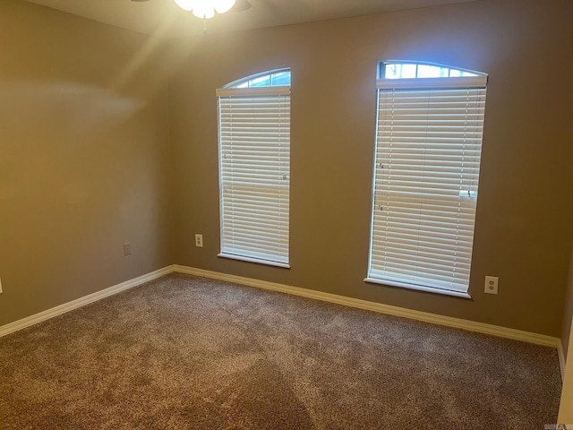 empty room featuring carpet flooring, ceiling fan, and plenty of natural light