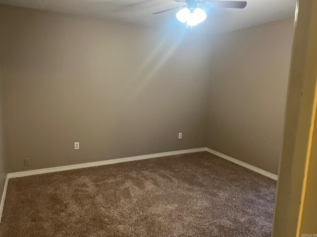 empty room with ceiling fan and carpet floors