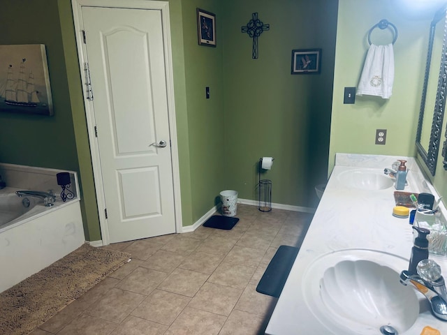 bathroom with tile patterned flooring, vanity, and a tub