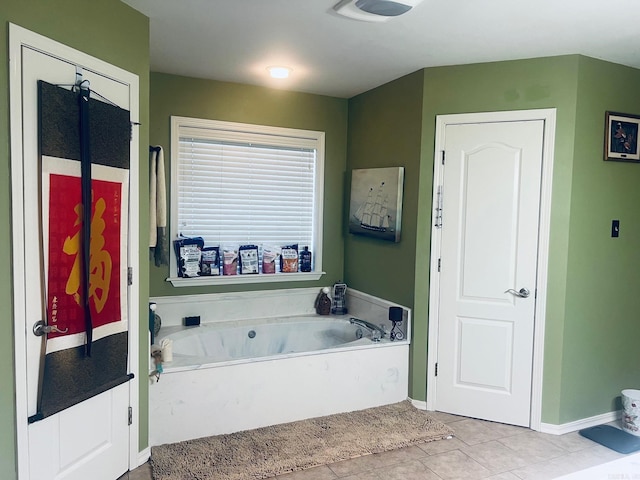 bathroom with tile patterned floors and a tub